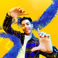 a young man is holding his hands up in front of a yellow and blue background